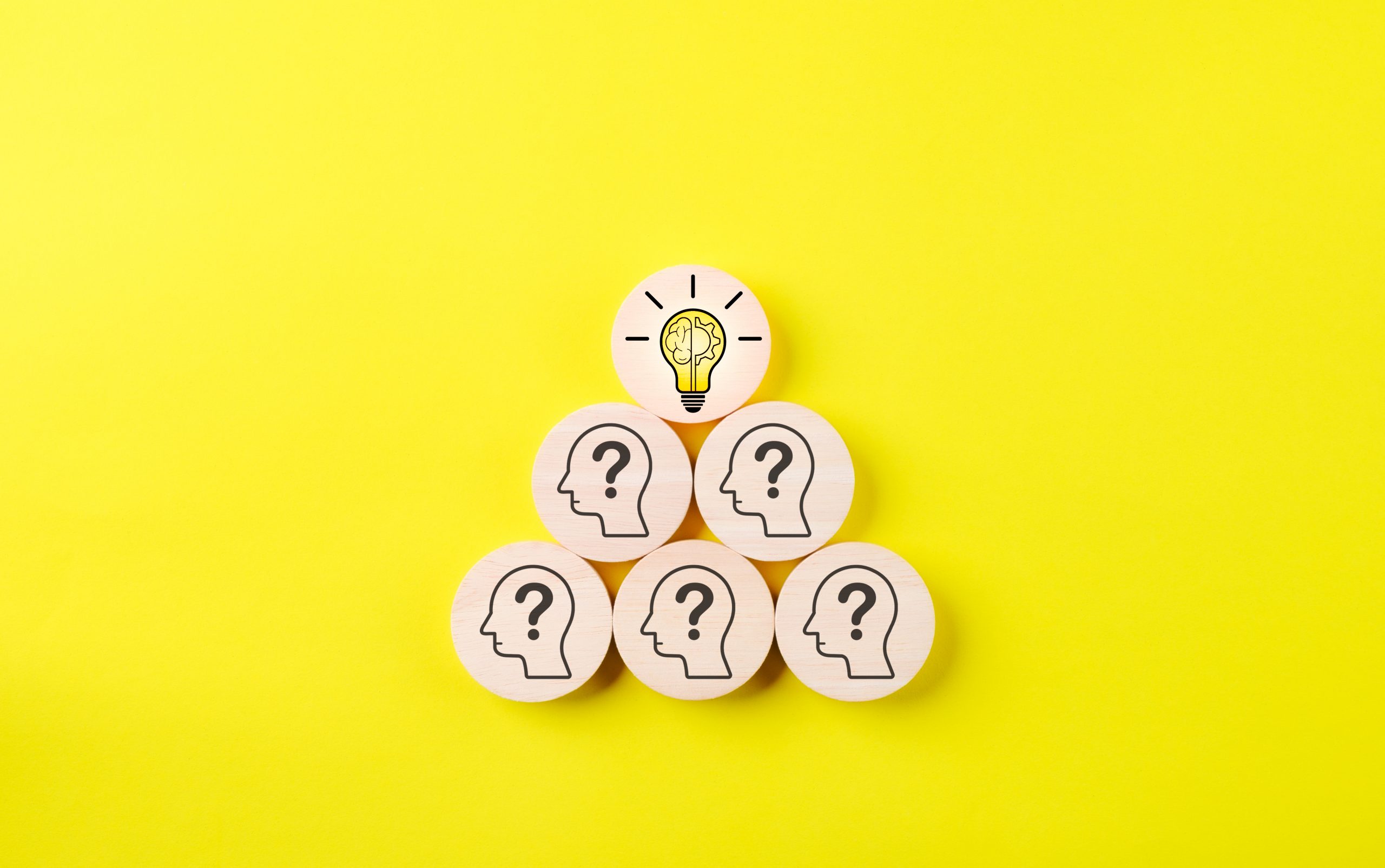 Wooden block into slot with human icon with many question marks. think idea, Using creative thinking to help solve problem. Innovation patent, Find solution, Brainstorming, Business strategy concept.